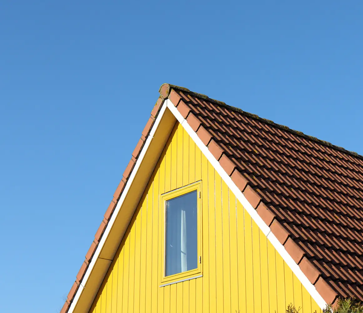 Yellow property beneath a blue sky