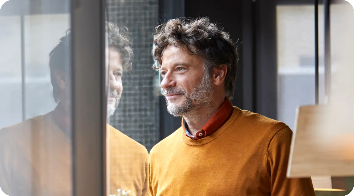A man looking through a window