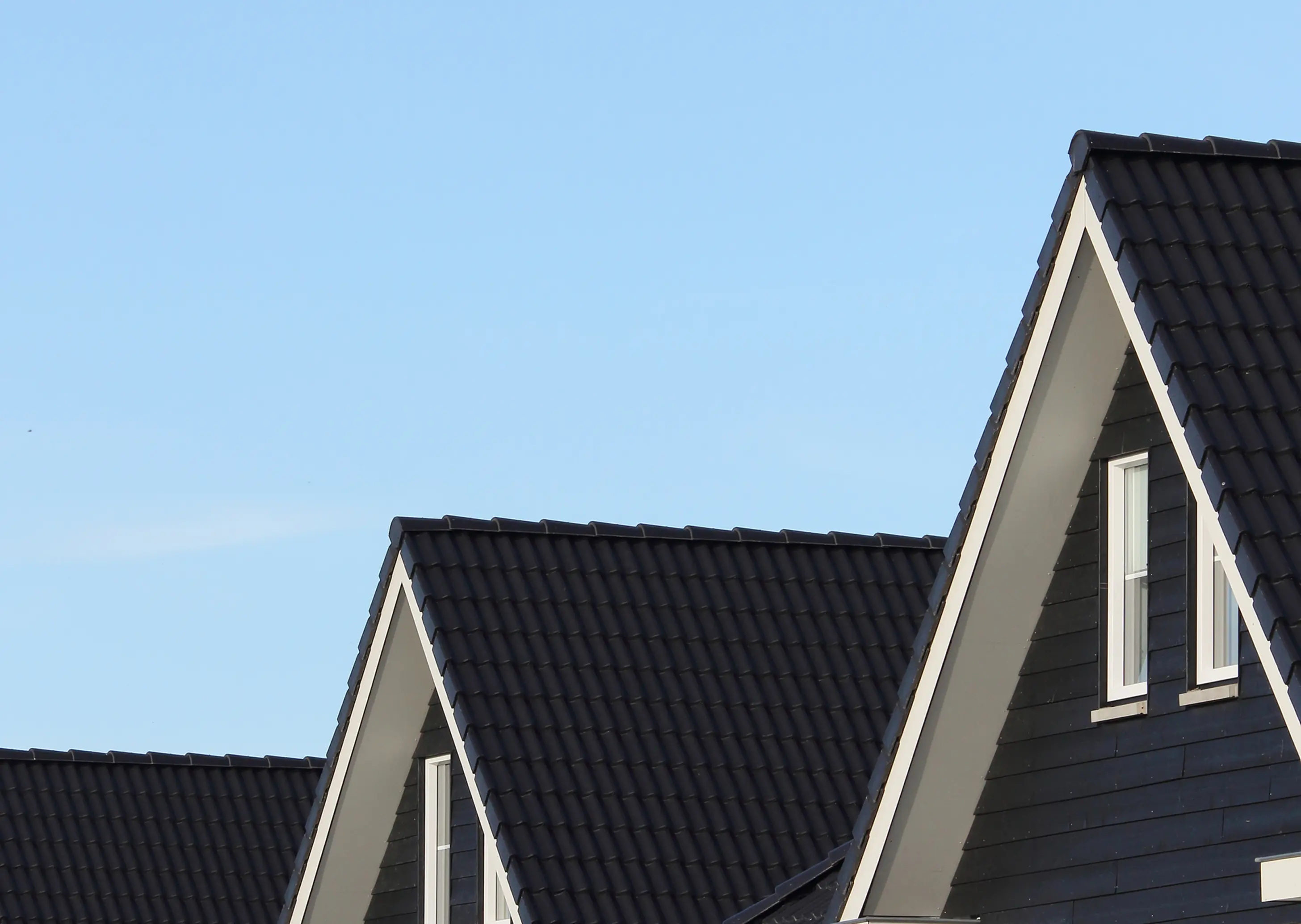 House rooftops beneath a blue sky