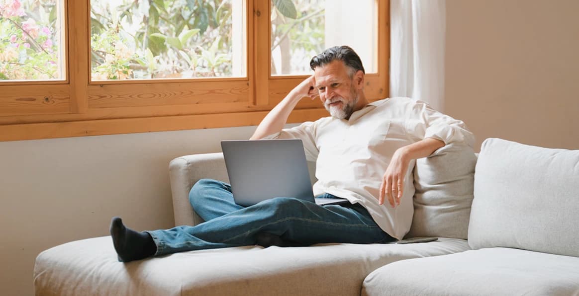 An investor working on a laptop at home